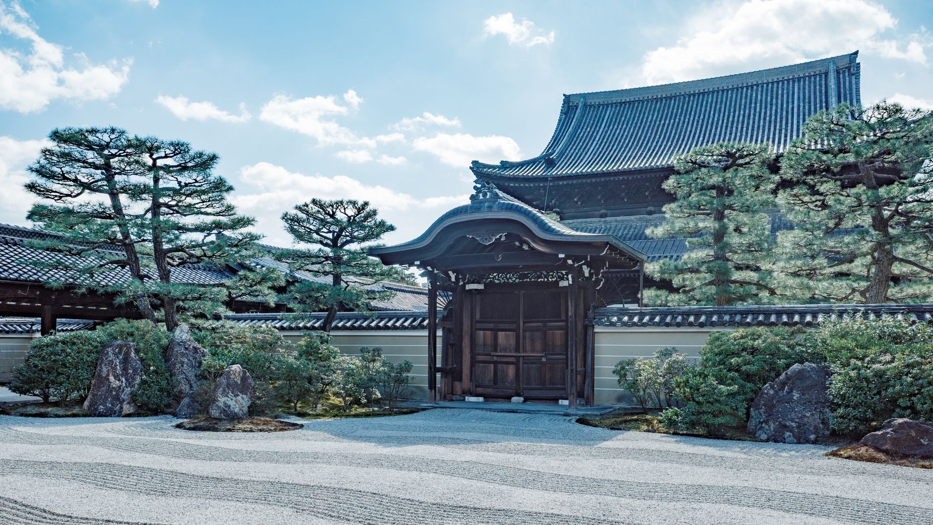 Japanese garden courtyard with raked gravel and wooden veranda