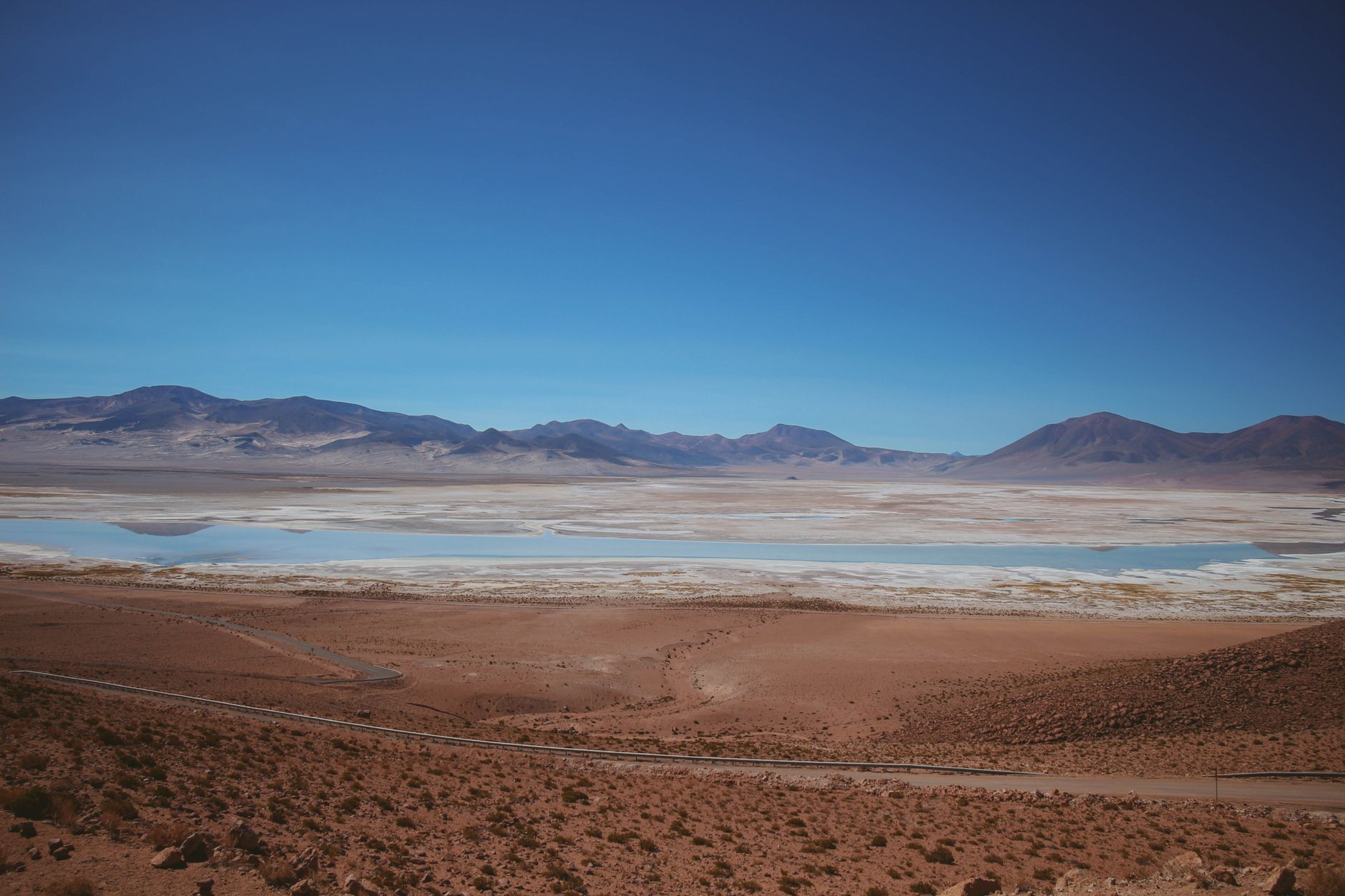 Expansive dry desert valley in northern Chile with distant volcanos